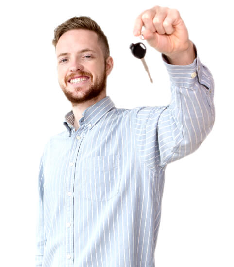 A smiling man with car keys in his hand